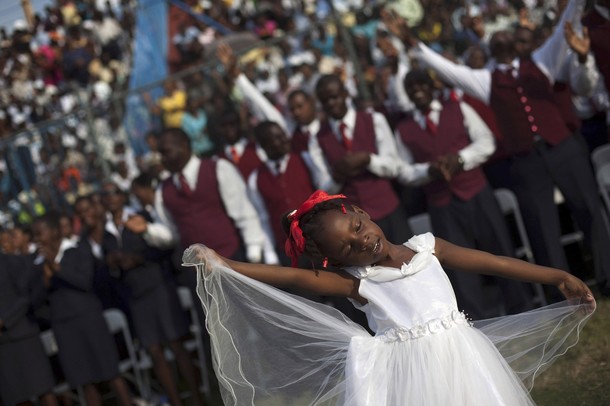 Achebelle Debora St. Til, 6, dances at the Festival of Hope at a soccer stadium in downtown Port-au-Prince