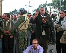 A protestor reads a devotional at a demonstration in Cairo against the Sool church attack