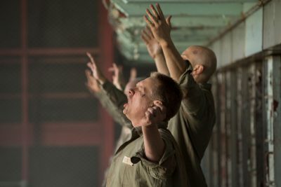 men-in-jail-hands-held-high-persecuted-church-war-on-christianity-The-Insanity-of-God