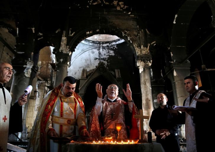 Iraqi priests hold the first Sunday mass at the Grand Immaculate Church since it was recaptured from Islamic State in Qaraqosh, near Mosul, Iraq, October 30, 2016. REUTERS/Ahmed Jadallah